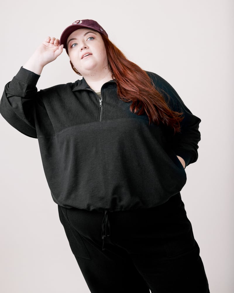 Front of a model wearing a size 3X Doris Cinched Half-Zip Sweatshirt in Amber Brown by ABLE. | dia_product_style_image_id:271519